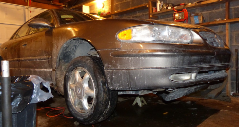 An image of the Buick on jack stands after the fix.
